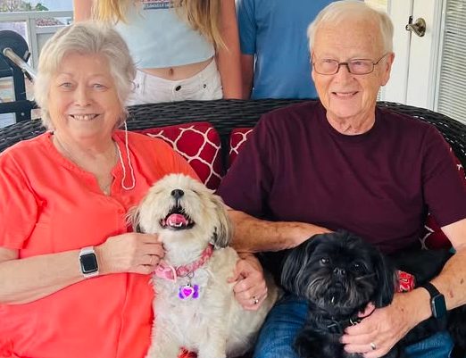 Woman and man with their dog after receiving a cochlear implant for Ménière’s disease.
