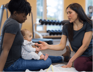 two friends and a child in the gym