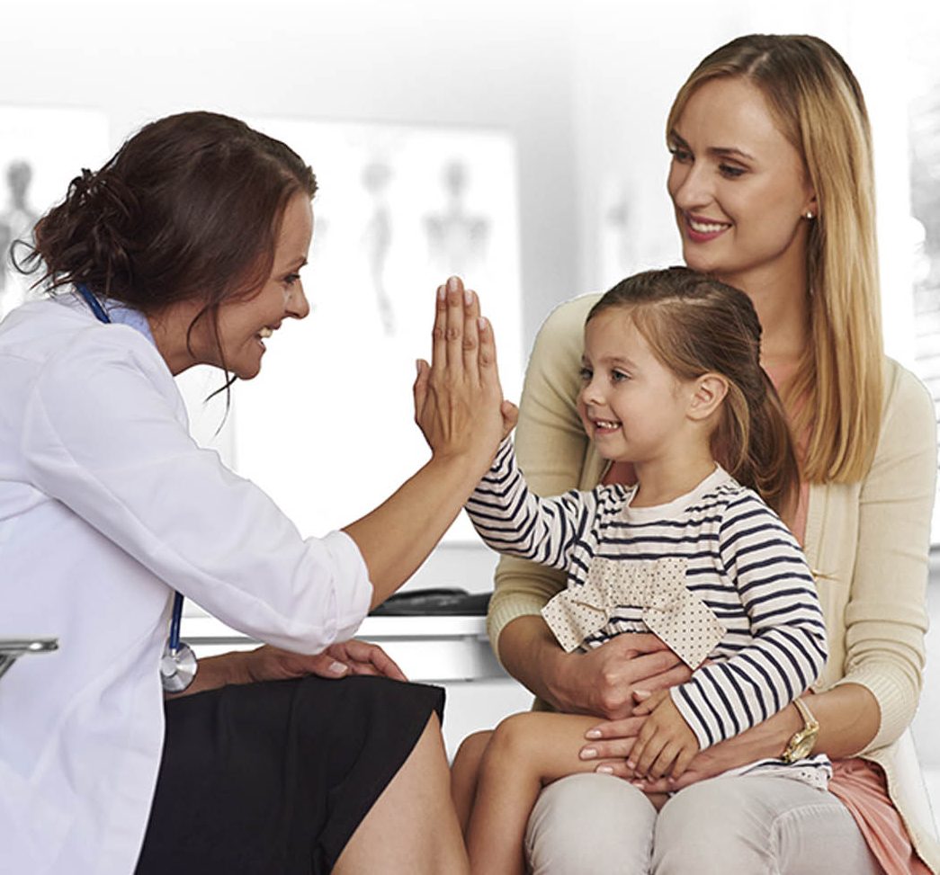 audiologist giving hi five to child cochlear implant candidate