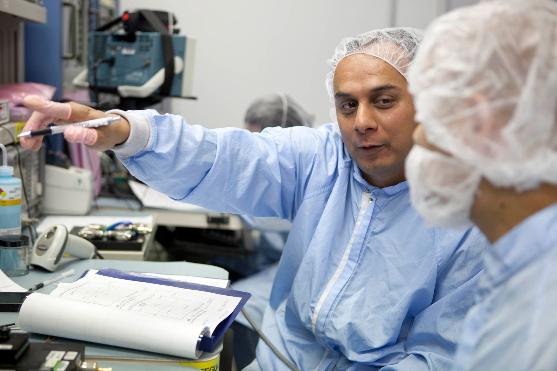 professionals on clean suits working in a lab
