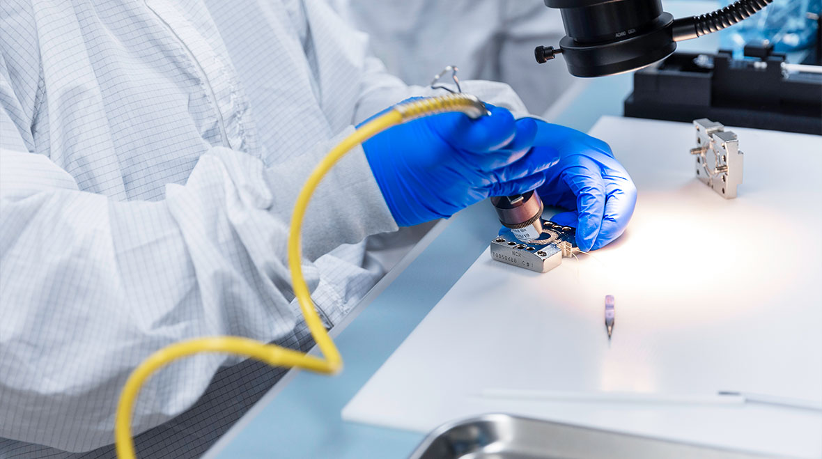 A medical technician works on a device