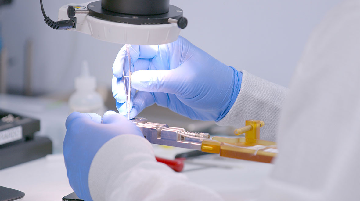A medical technician works on a device
