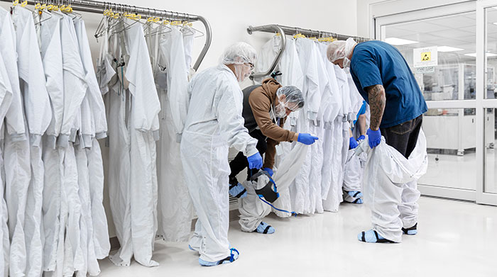 A group of medical professionals try fitting in some protective gear