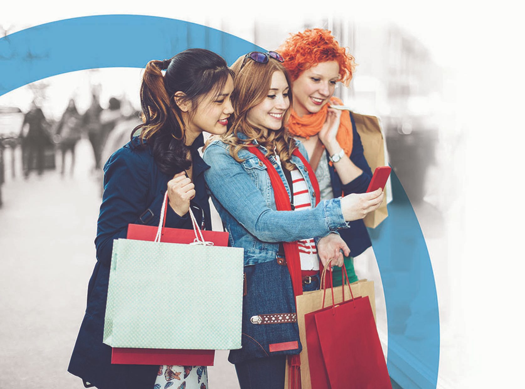 three young adults shopping and laughing at the mall while using mobile device