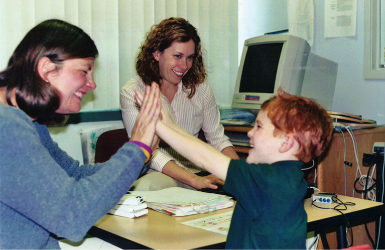 Matthew working with therapists during early hearing interventions, a key step in his cochlear implant revision surgery process.