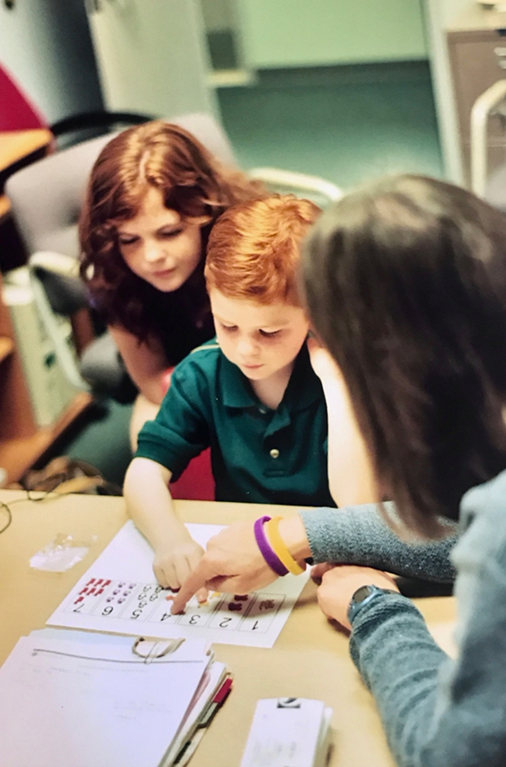 Matthew learning sign and spoken language, an important part of his cochlear implant procedure experience.