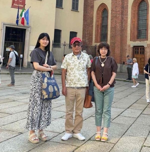 a man, woman, and their daughter pose for a family photo
