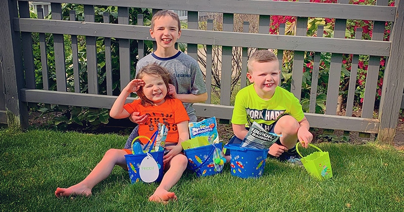 The children of a mother with a cochlear implant pose for a picture
