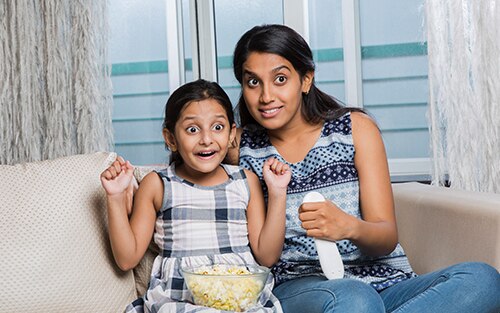 Mother and daughter immersing in an enhanced entertainment experience.