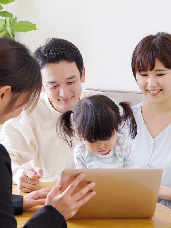 family gathered around a laptop reading together