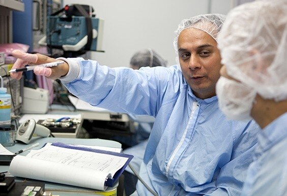 professionals on clean suits working in a lab