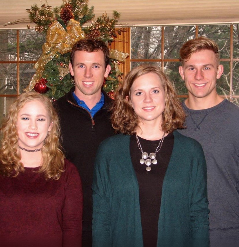 hamilton and his family gathered around christmas tree