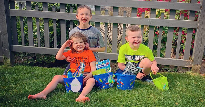 The children of a mother with a cochlear implant pose for a picture