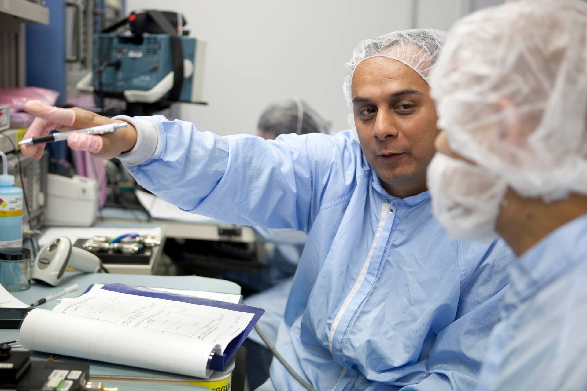 professionals on clean suits working in a lab