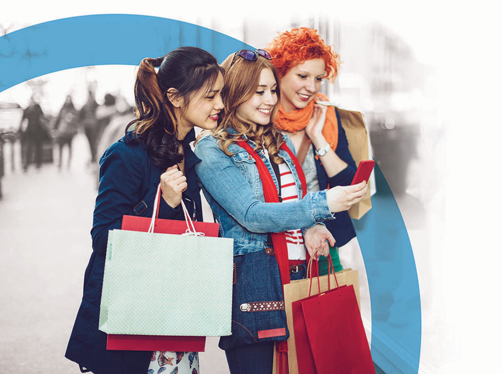 three young adults shopping and laughing at the mall while using mobile device