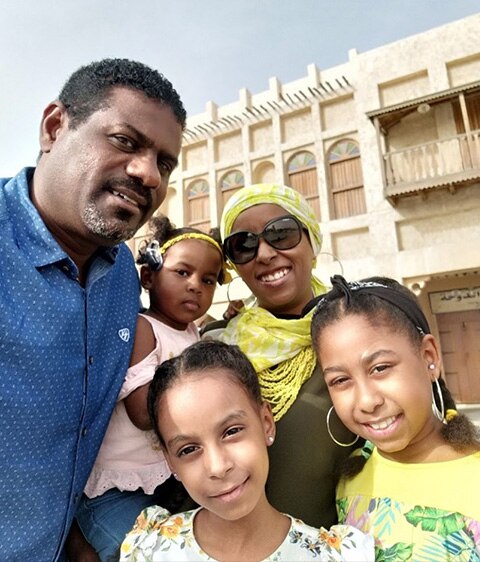 Family takes picture with their daughter with a cochlear implant