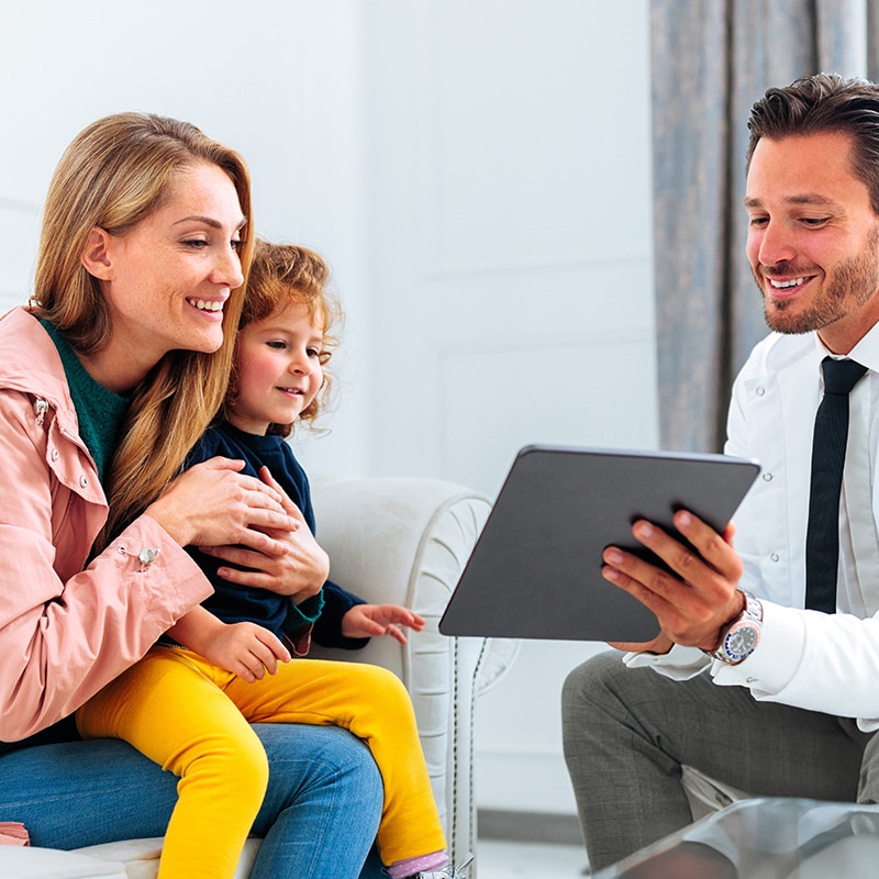 a parent and child are consulted by a hearing professional about cochlear implants.