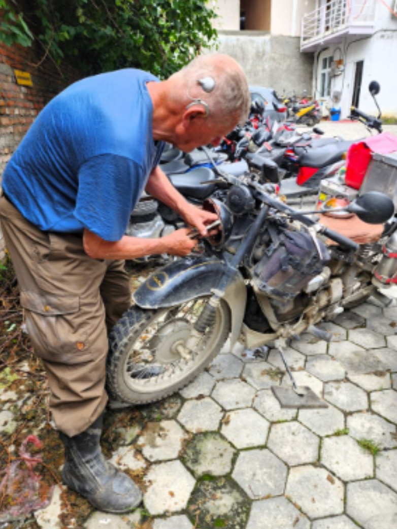 blog author Knud Erik works on his motorcycle