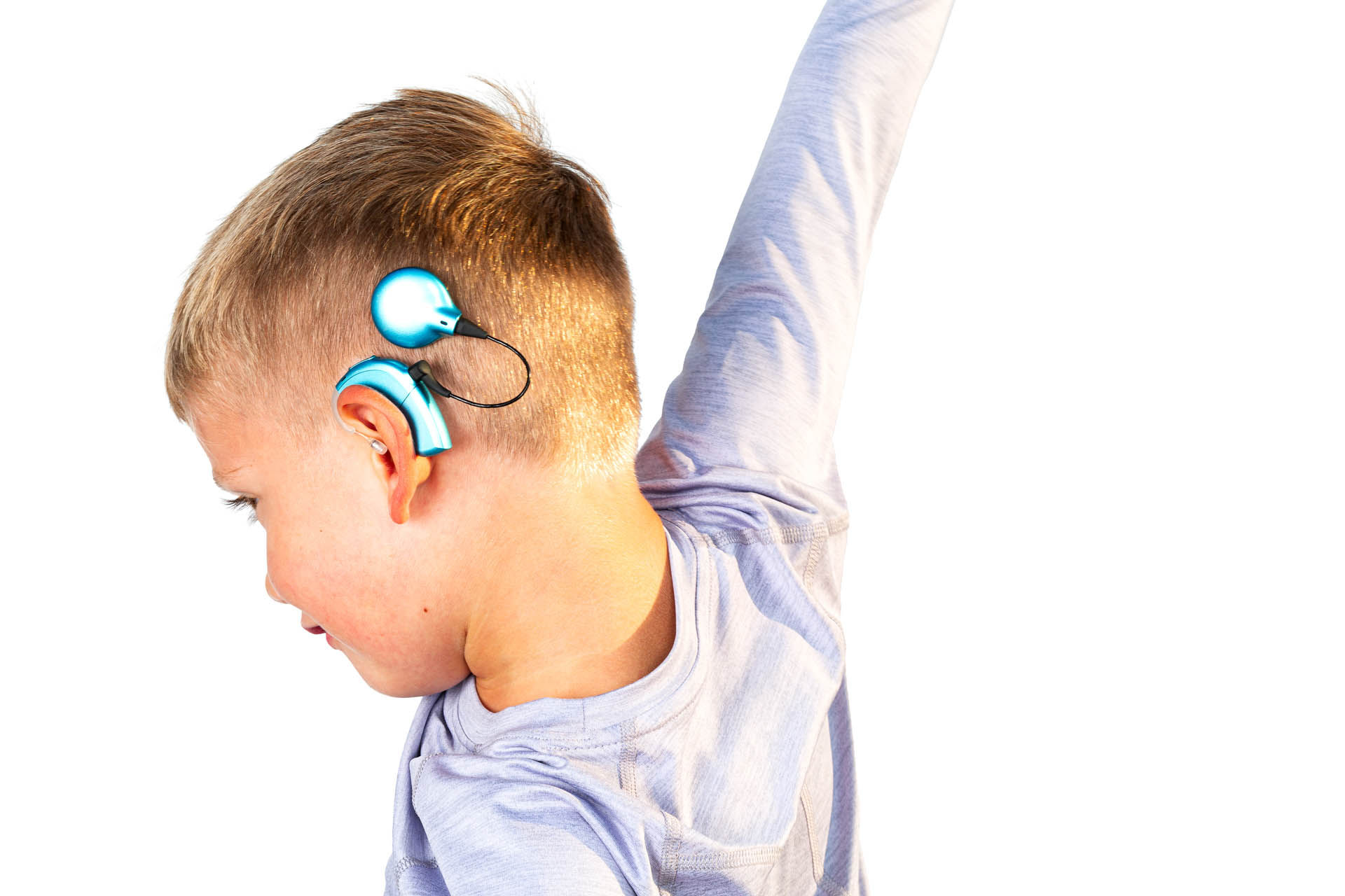 active kid with cochlear implant worn behind the ear