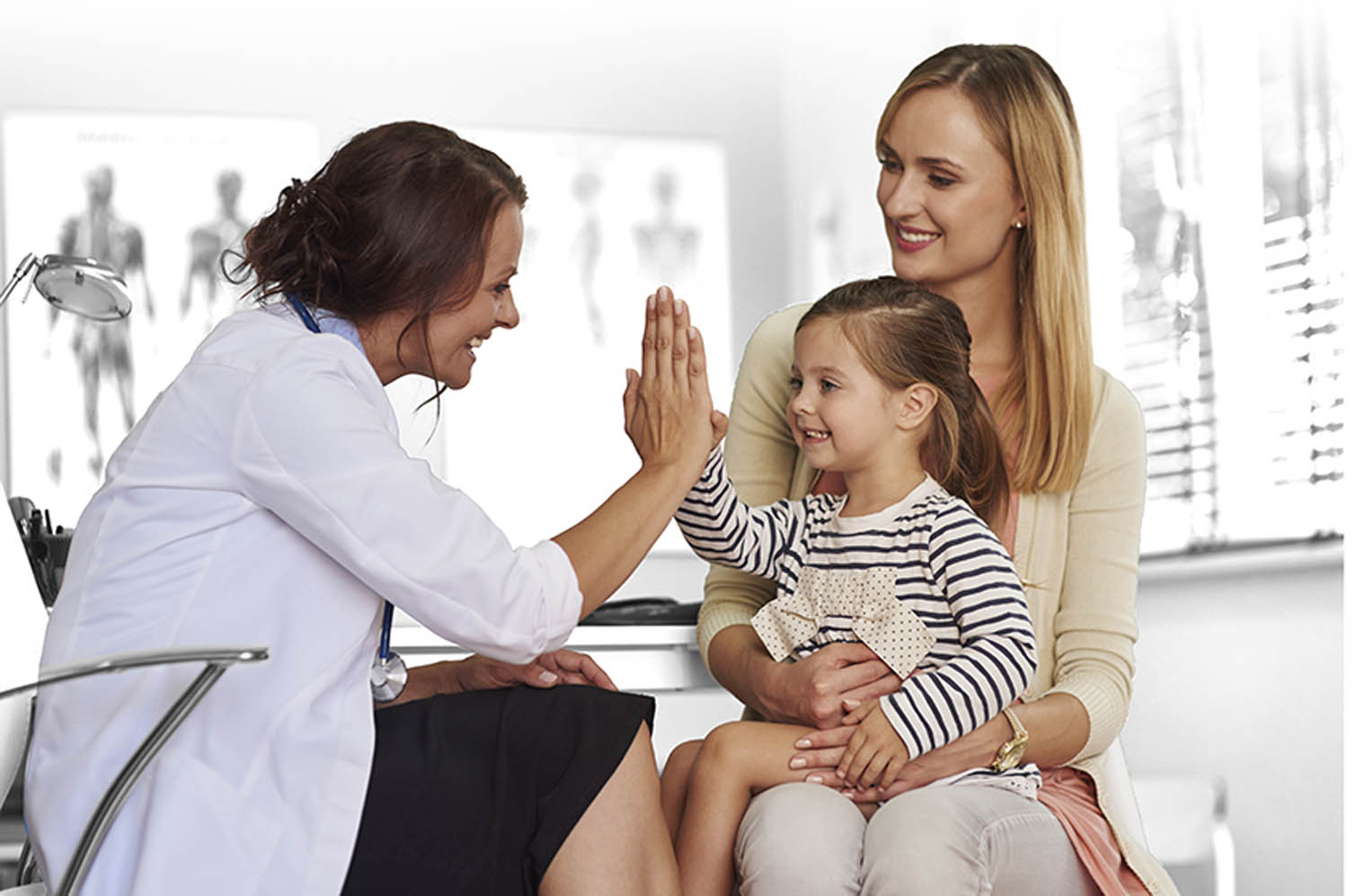 Audiologist gives hi-five to child CI candidate