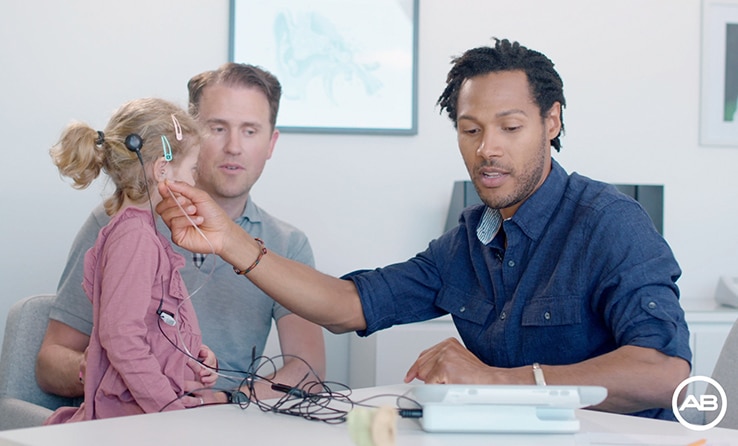 an audiologist using aim on child cochlear implant recipient